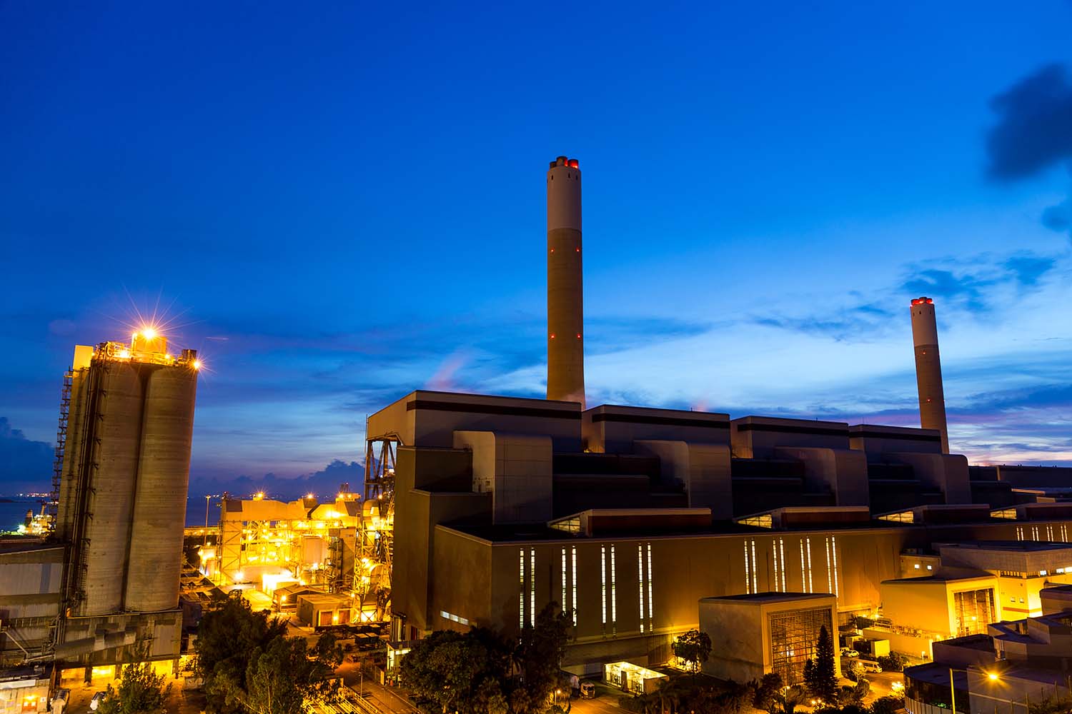 Evening image of a power plant that has cooling tower fill